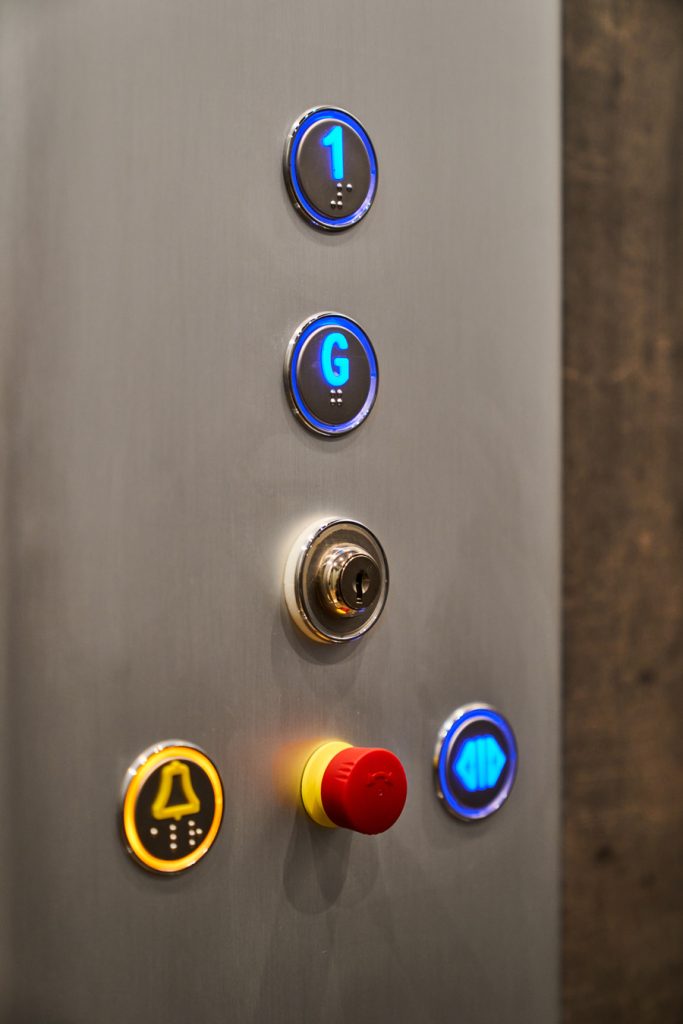 Close up image of round buttons on HLB Elevator